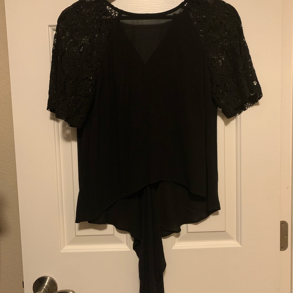 Sheer quarter sleeved Black lace top with tie in back.